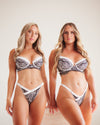 Two models wearing a lace lingerie set against a plain background blonde curvy and fit models