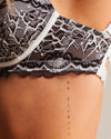 Black lace lingerie with a tattoo on skin